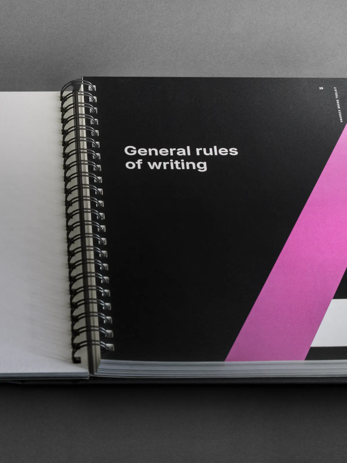 Anarock brand book page titled 'General rules of writing' with a pink triangular accent